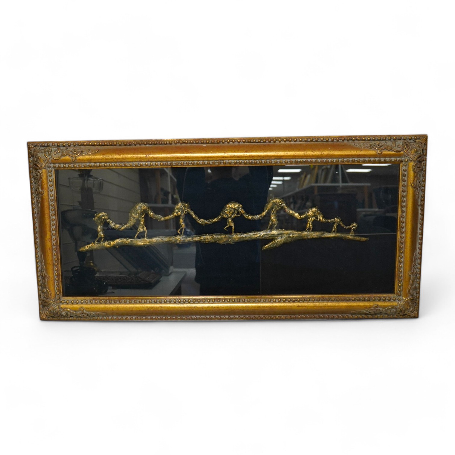 A framed bronze sculpture, of fishermen carrying rolled fishing net, 86cm wide x 33.5cm high.Condition - good